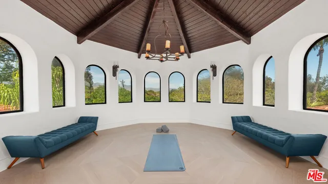 a living room with furniture a flat screen tv and a table