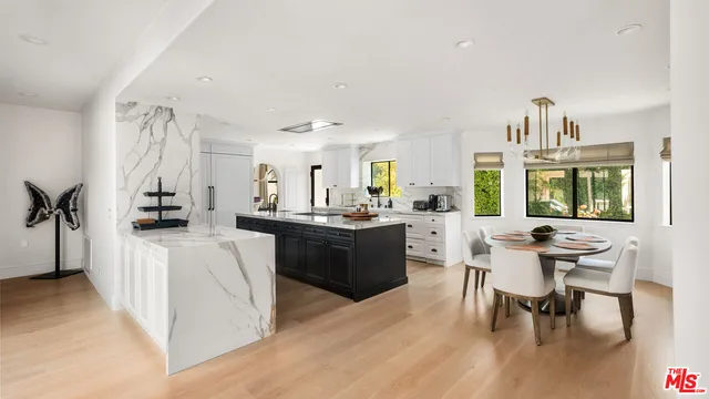 a kitchen with white cabinets a sink dishwasher and a stove