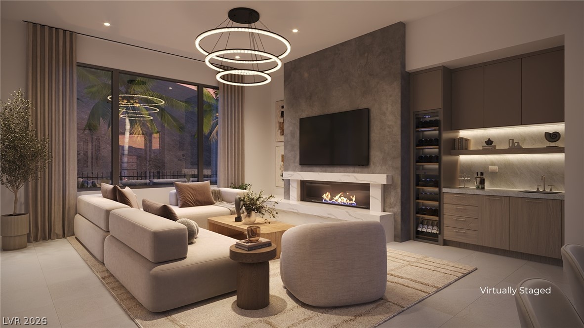 505 Overlook Rim Drive Henderson, NV 89012 - Photo 7 of 22 A modern living space features a linear fireplace and a sophisticated wet bar, offering stylish comfort.
