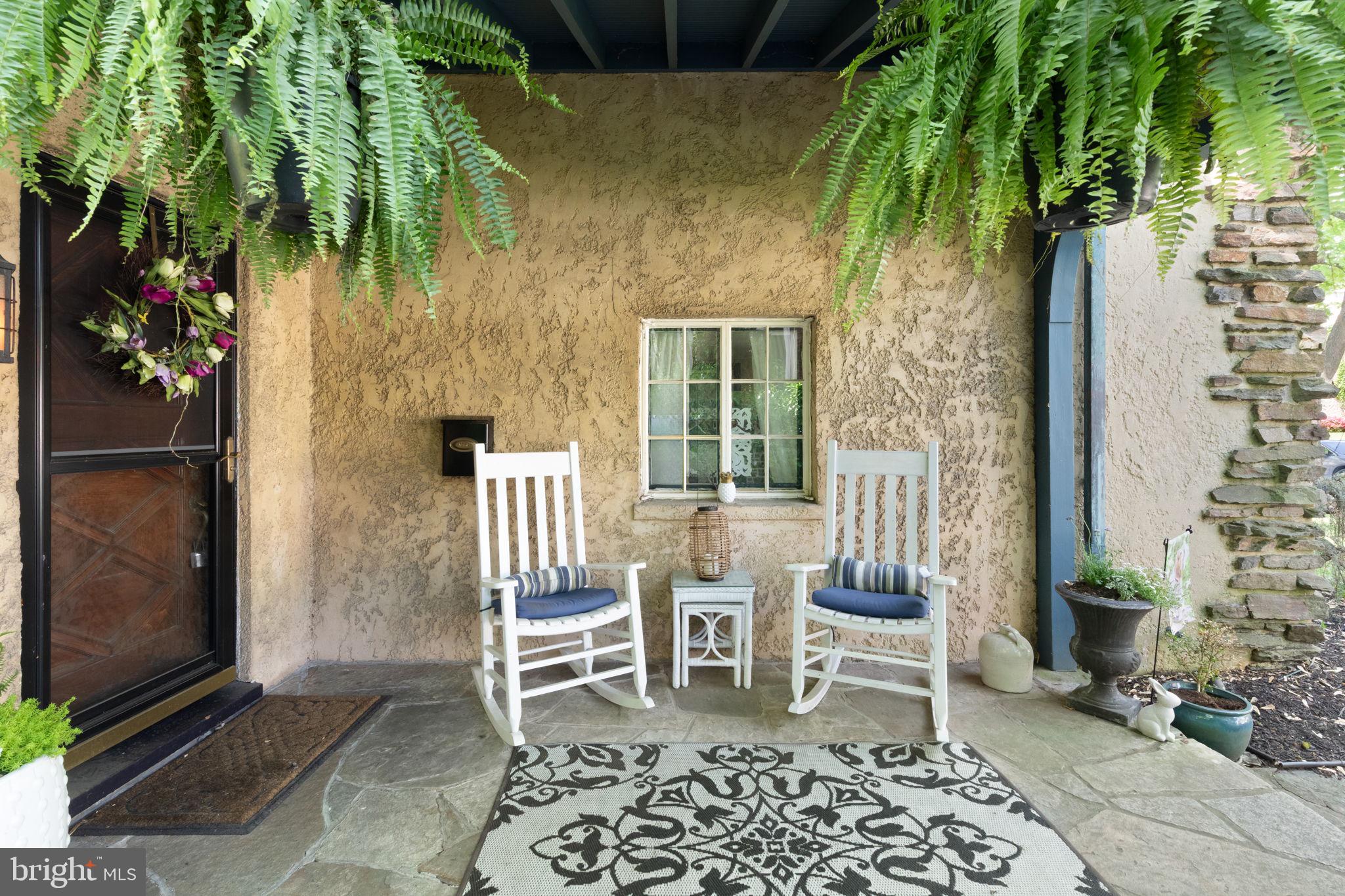 311 Taplow Road Baltimore, MD 21212 - Photo 4 of 32 a porch with a table and chairs and potted plants