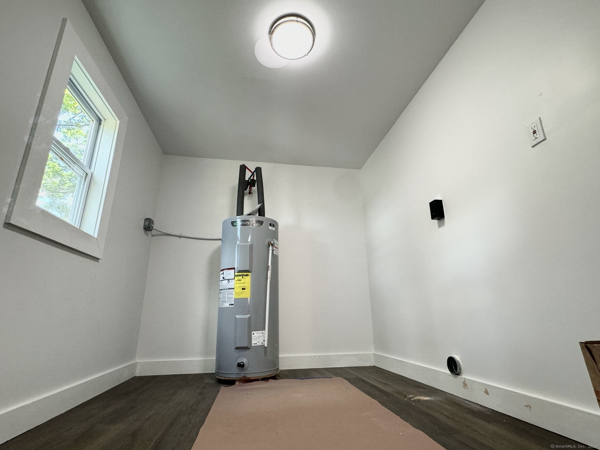 22 Hemlock Trail Newtown, CT 06482 - Photo 28 of 31 wooden floor in an empty room with a window