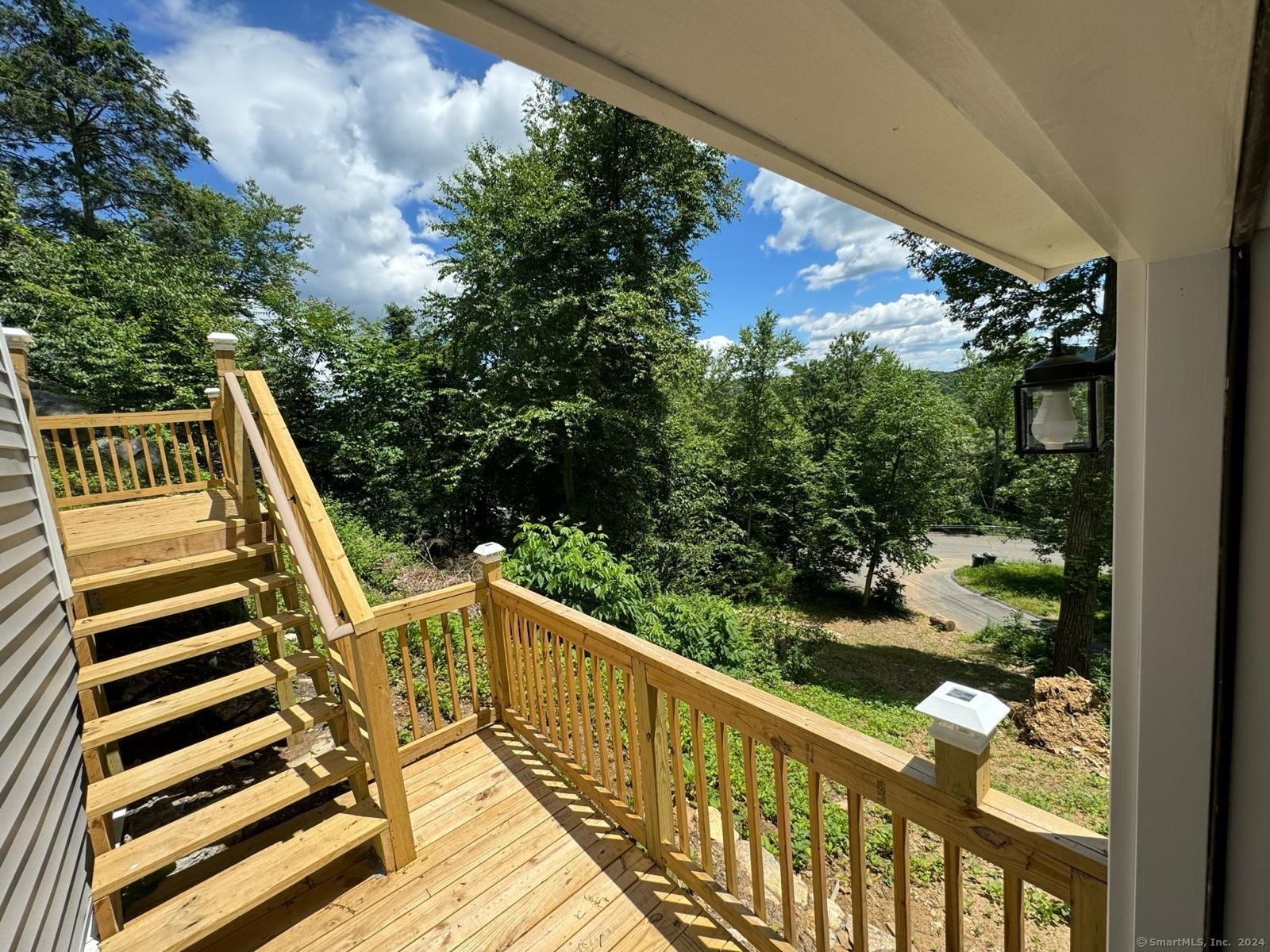 22 Hemlock Trail Newtown, CT 06482 - Photo 9 of 31 a view of a balcony with wooden floor and fence