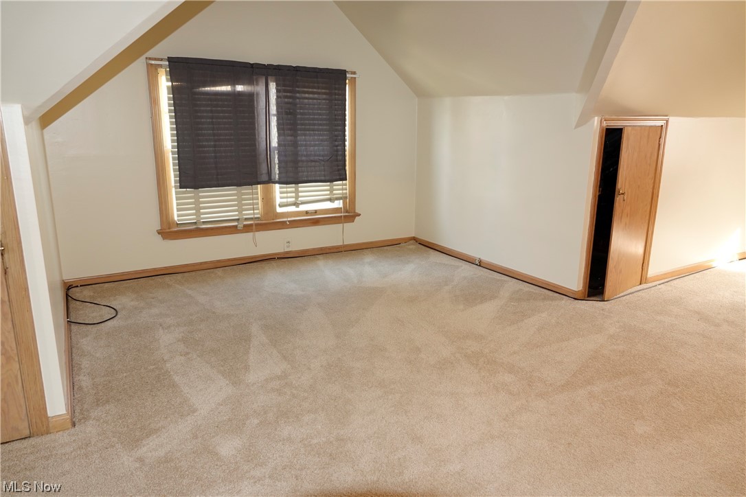 5376 Huron Road Cleveland, OH 44124 - Photo 21 of 32 Carpeted spare room featuring lofted ceiling