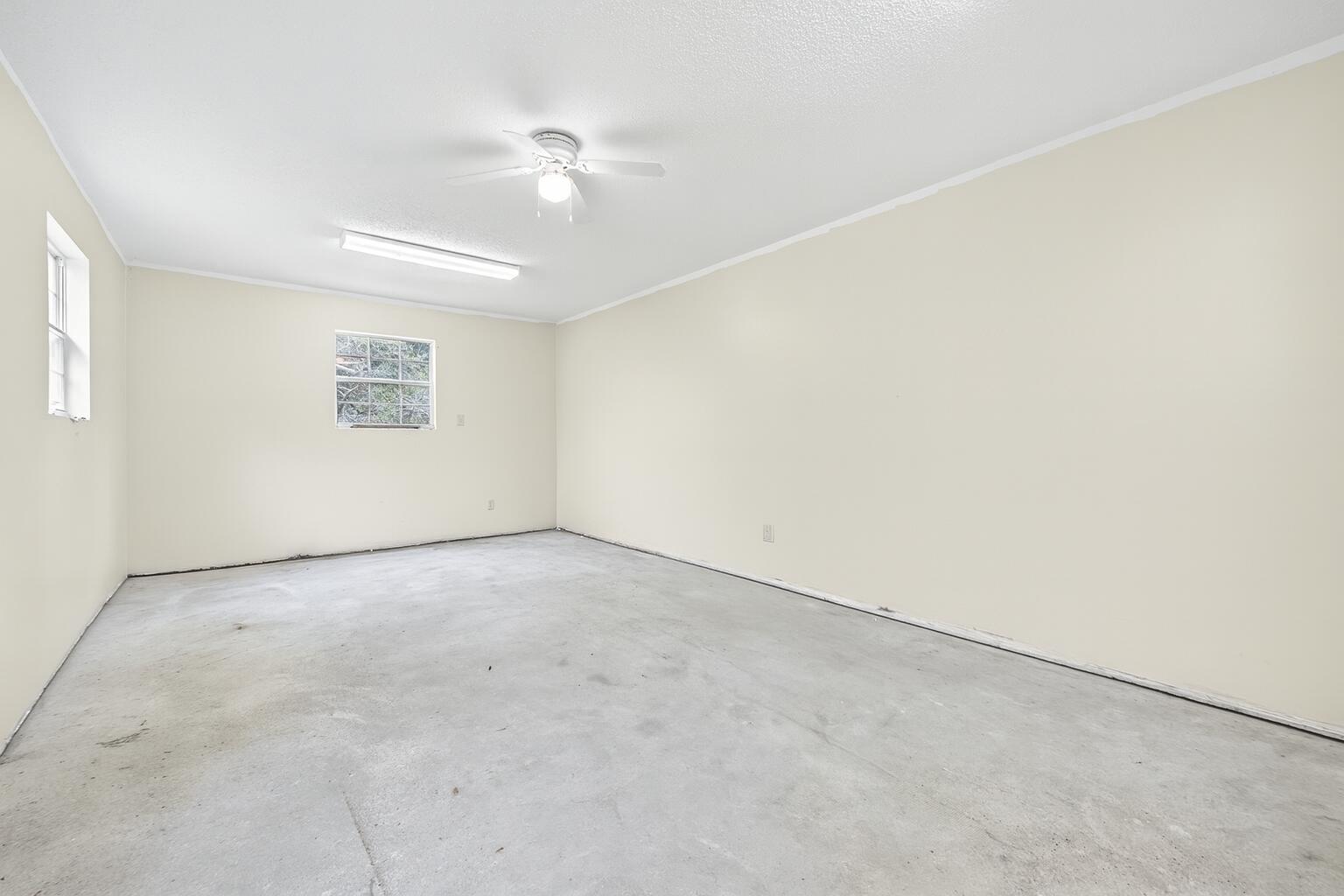 5378 Staghorn Road Crestview, FL 32539 - Photo 105 of 130 an empty room with a ceiling fan and window