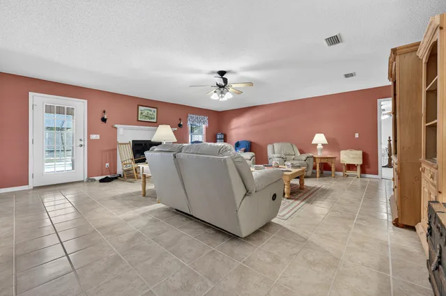a view of a dining room with furniture and a chandelier