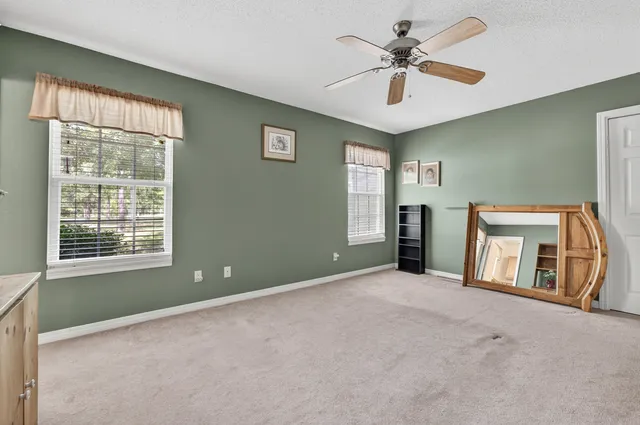 a view of a livingroom with furniture and a window