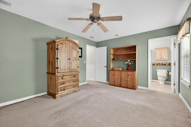 a view of a backyard and wooden fence