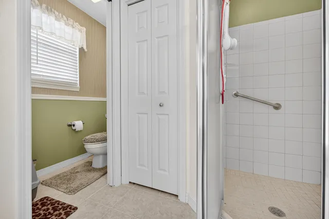 an empty room with a ceiling fan and window