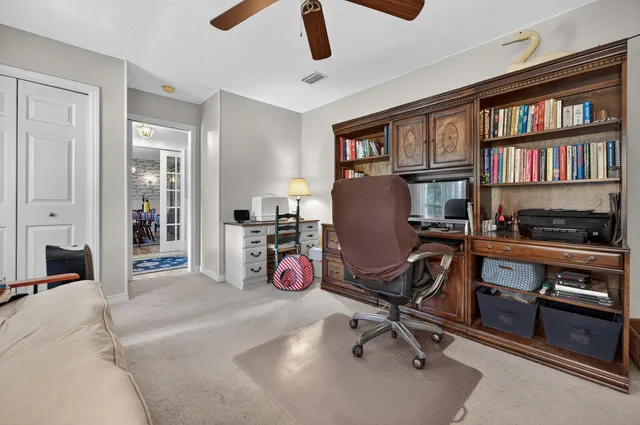a view of a workspace with furniture and a window