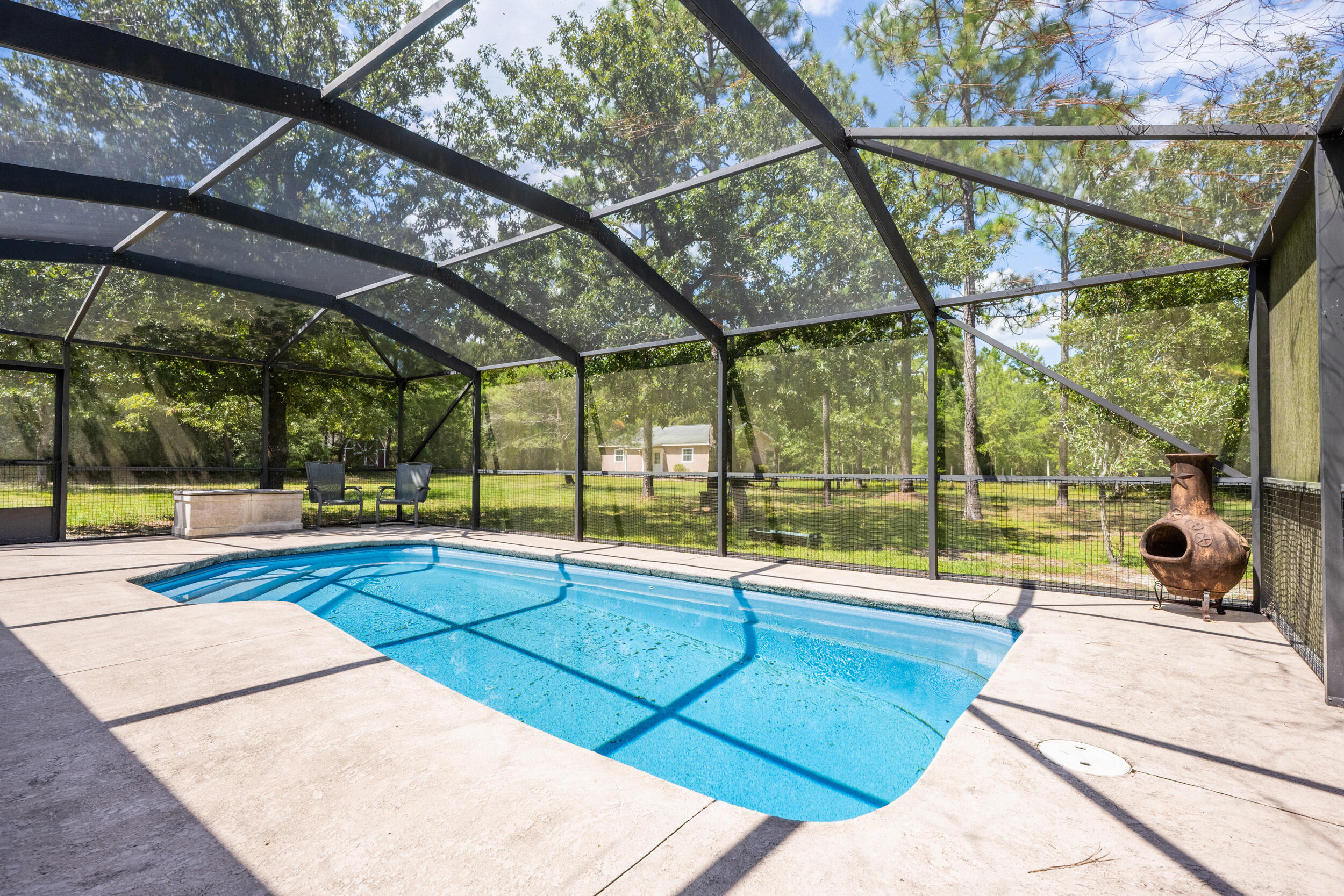 5378 Staghorn Road Crestview, FL 32539 - Photo 58 of 130 a view of a swimming pool with a porch