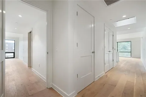 a view of hallway with wooden floor