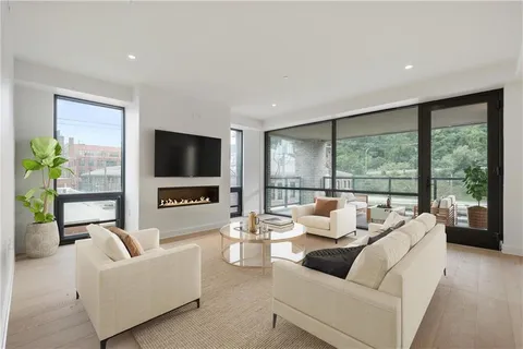 a living room with furniture tv and a large window