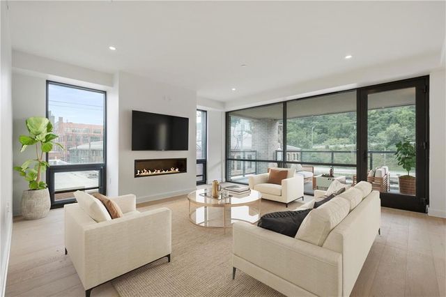 a living room with furniture tv and a large window