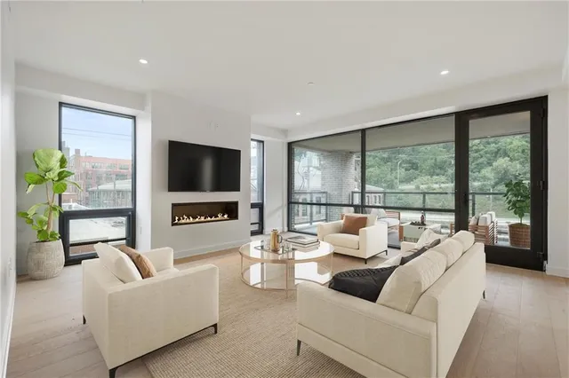 a living room with furniture tv and a large window