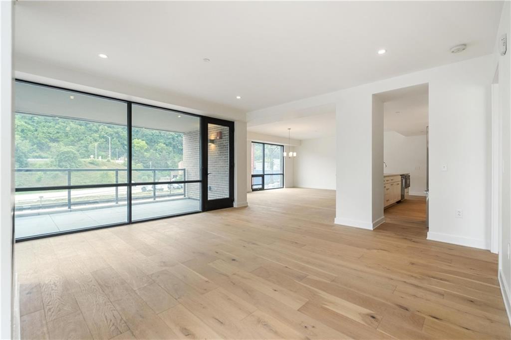 2330 Penn Avenue, Unit 302 Pittsburgh, PA 15222 - Photo 16 of 27 a view of an empty room with wooden floor and a window