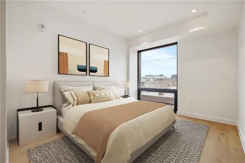 a bedroom with a large bed and a window