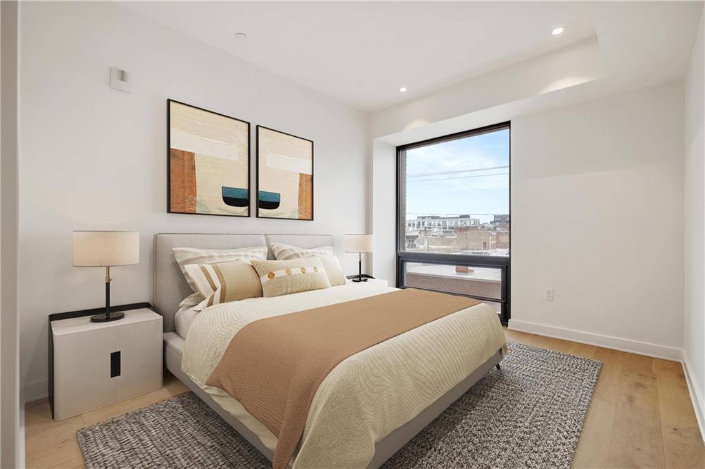 2330 Penn Avenue, Unit 302 Pittsburgh, PA 15222 - Photo 17 of 27 a bedroom with a large bed and a window