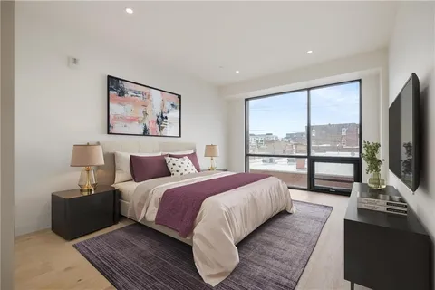 a bed room with a bed and a large window