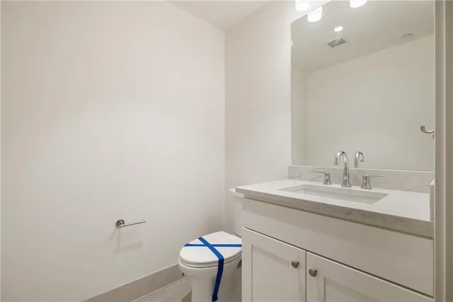a bathroom with a sink toilet and a mirror
