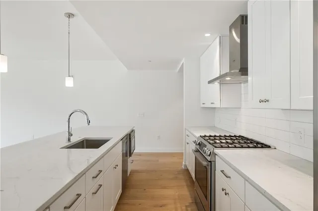a kitchen with stainless steel appliances a sink a stove and a refrigerator