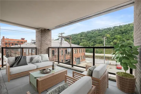 a living room with furniture and a potted plant