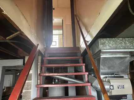a view of staircase with white walls and a window