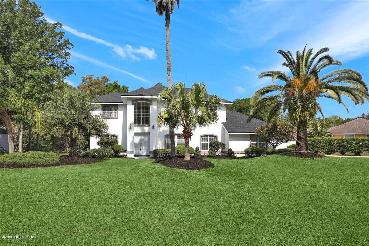 3317 Kings Road South St. Augustine, FL 32086 - Photo 1 of 32 a front view of a house with a garden and trees