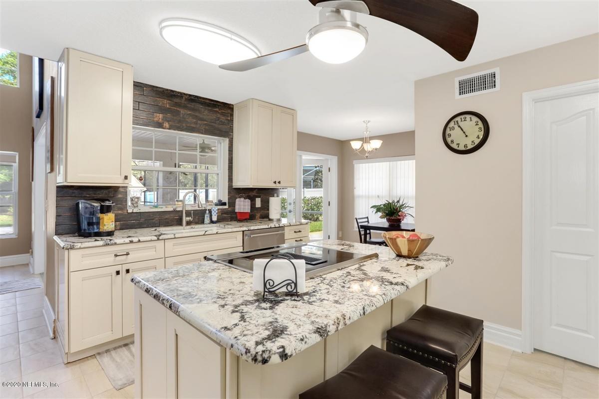 3317 Kings Road South St. Augustine, FL 32086 - Photo 12 of 32 a view of a kitchen area with furniture and wooden floor