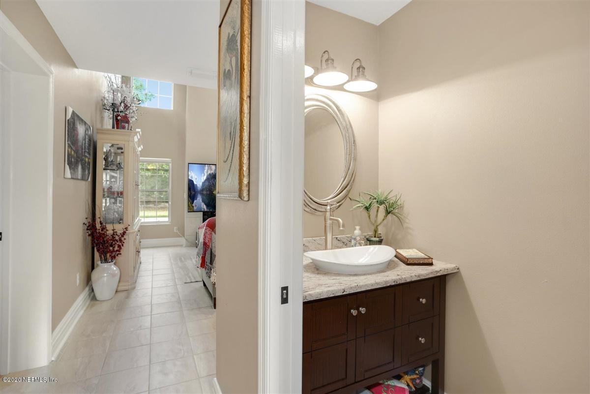 3317 Kings Road South St. Augustine, FL 32086 - Photo 10 of 32 a bathroom with a sink vanity and a mirror