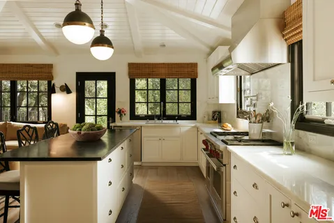 a kitchen with a sink stove and cabinets