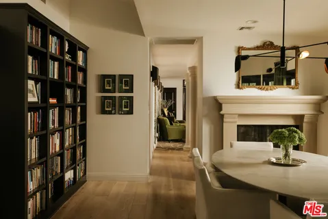 a view of living room with furniture and book shelf