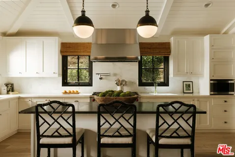 a kitchen with a table and chairs in it