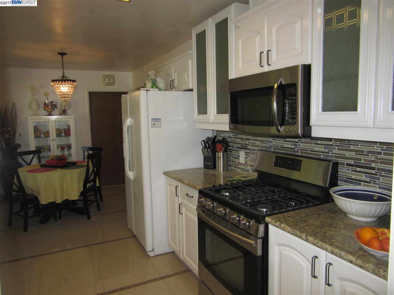 16373 Austin Road Manteca, CA 95336 - Photo 4 of 16 a kitchen with a stove a sink and a refrigerator