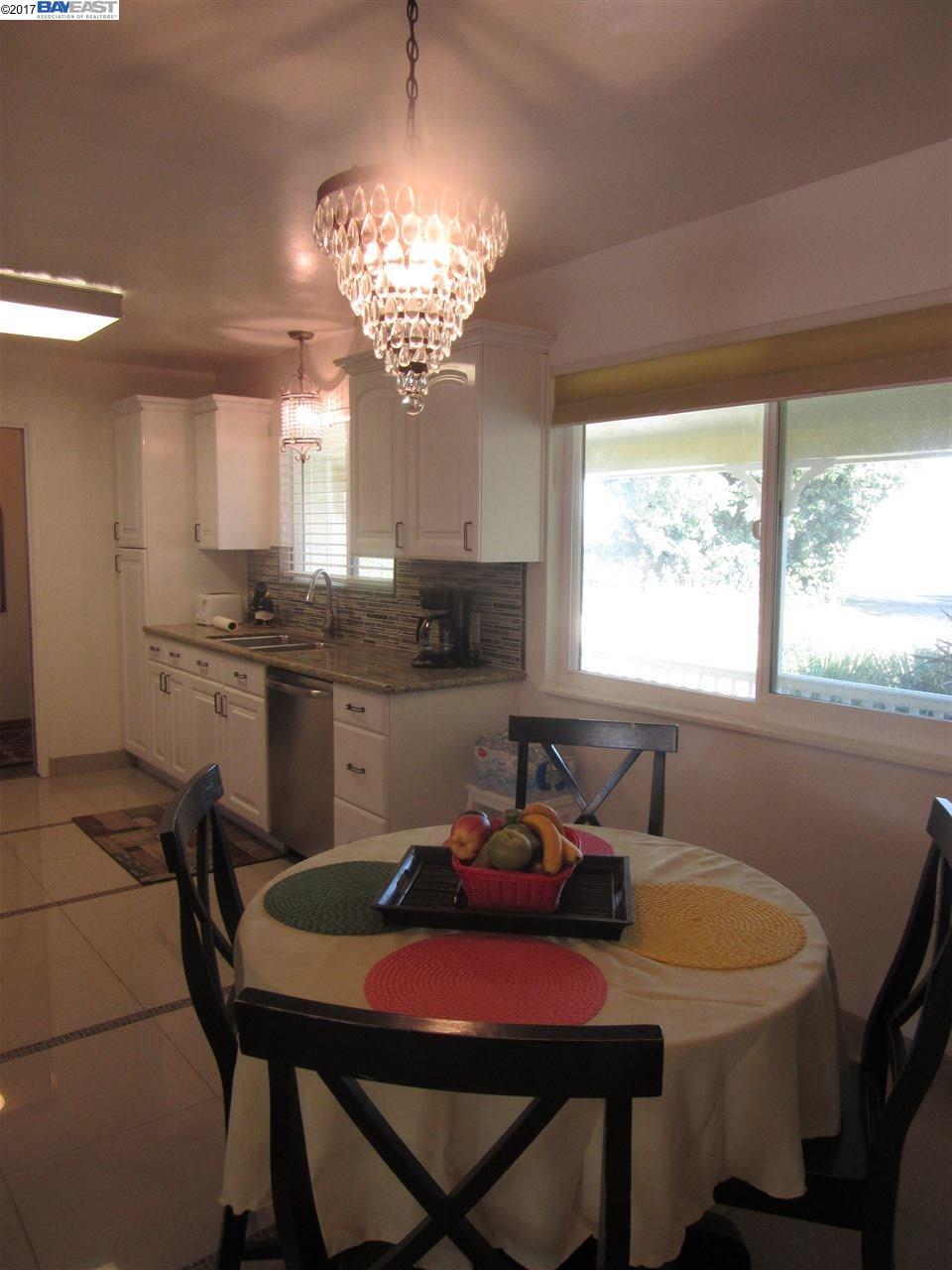 16373 Austin Road Manteca, CA 95336 - Photo 5 of 16 a view of a dining room with furniture a chandelier and window