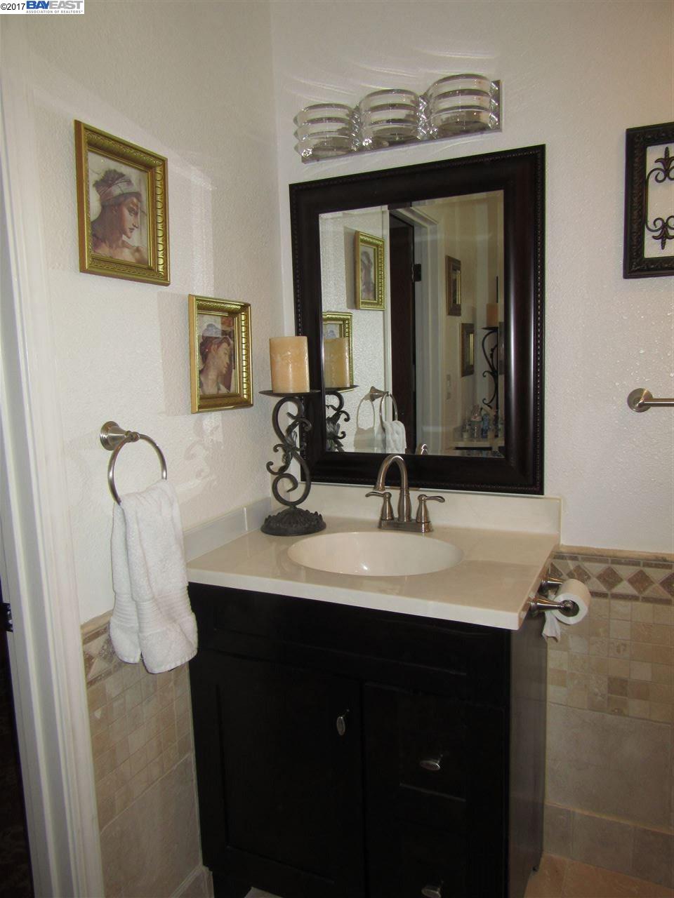 16373 Austin Road Manteca, CA 95336 - Photo 8 of 16 a bathroom with a double vanity sink and a mirror