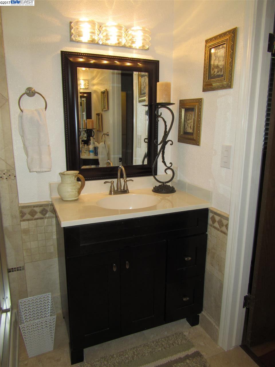 16373 Austin Road Manteca, CA 95336 - Photo 9 of 16 a bathroom with a sink vanity and a mirror