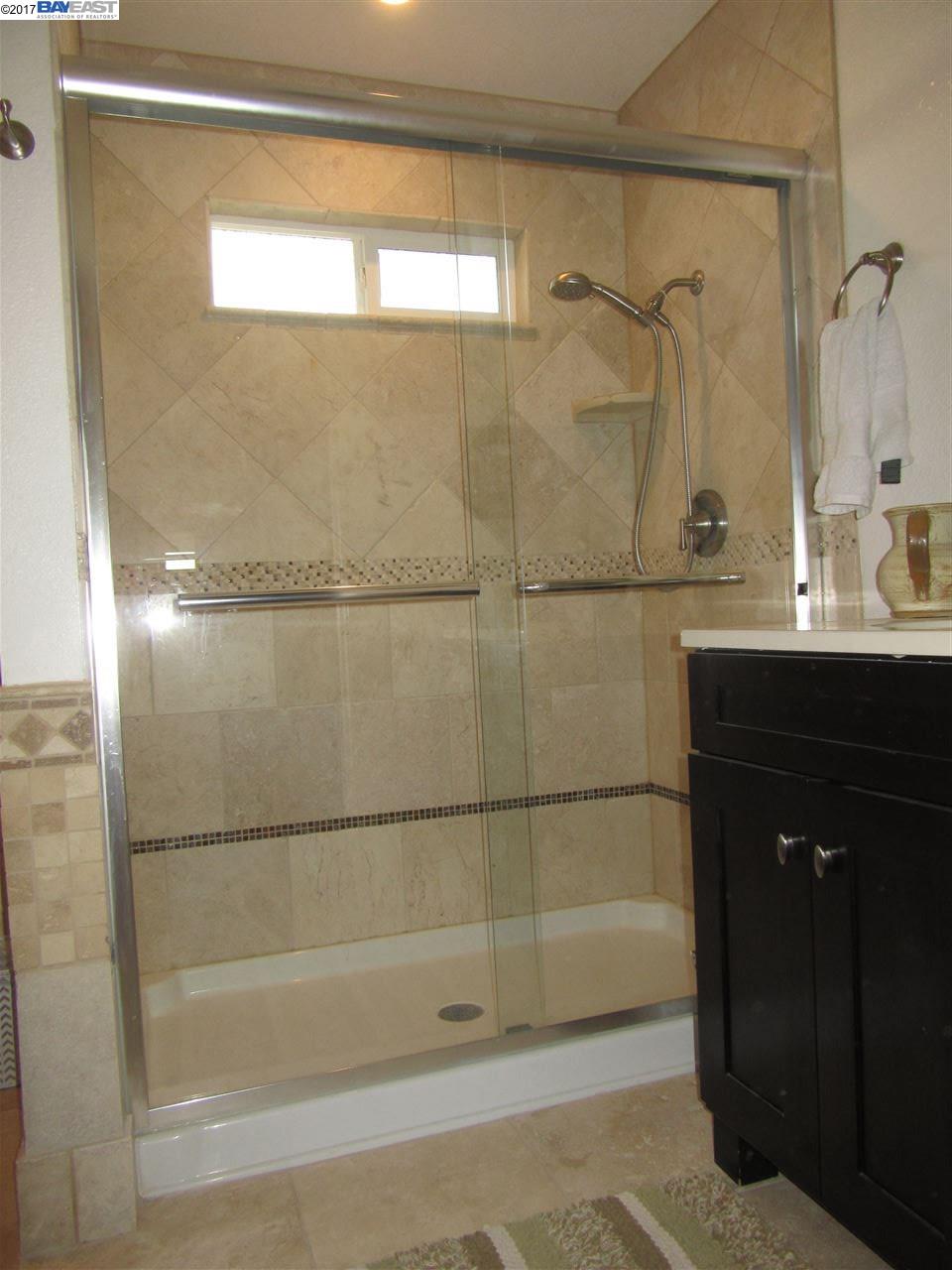 16373 Austin Road Manteca, CA 95336 - Photo 10 of 16 a bathroom with a shower and a sink
