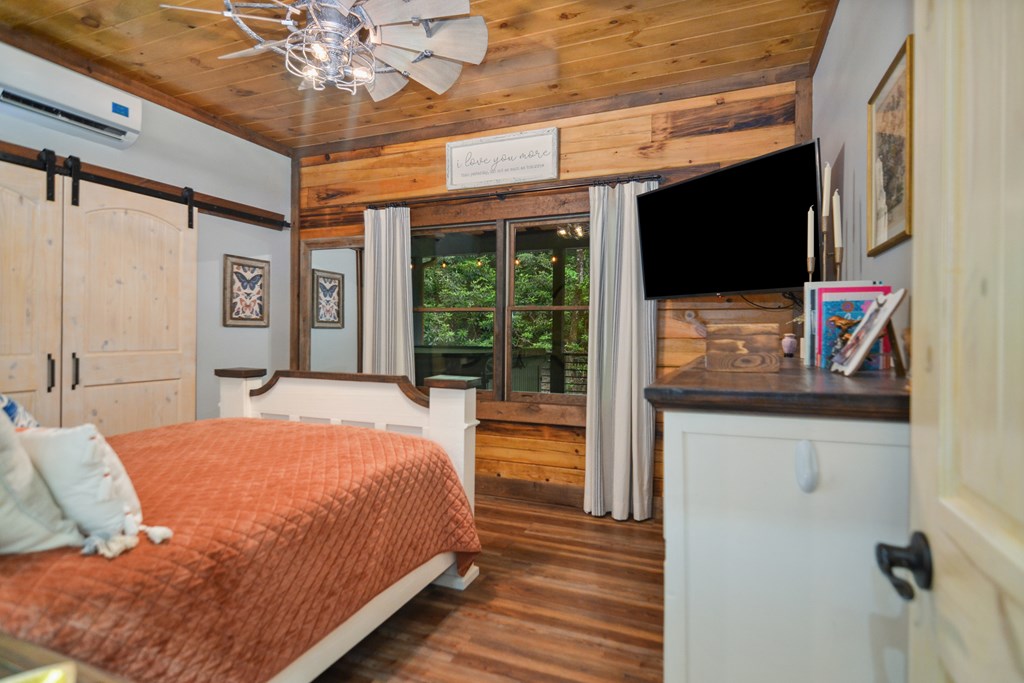 17 Emmaus Walk Blue Ridge, GA 30513 - Photo 19 of 59 a bedroom with a bed and a flat screen tv