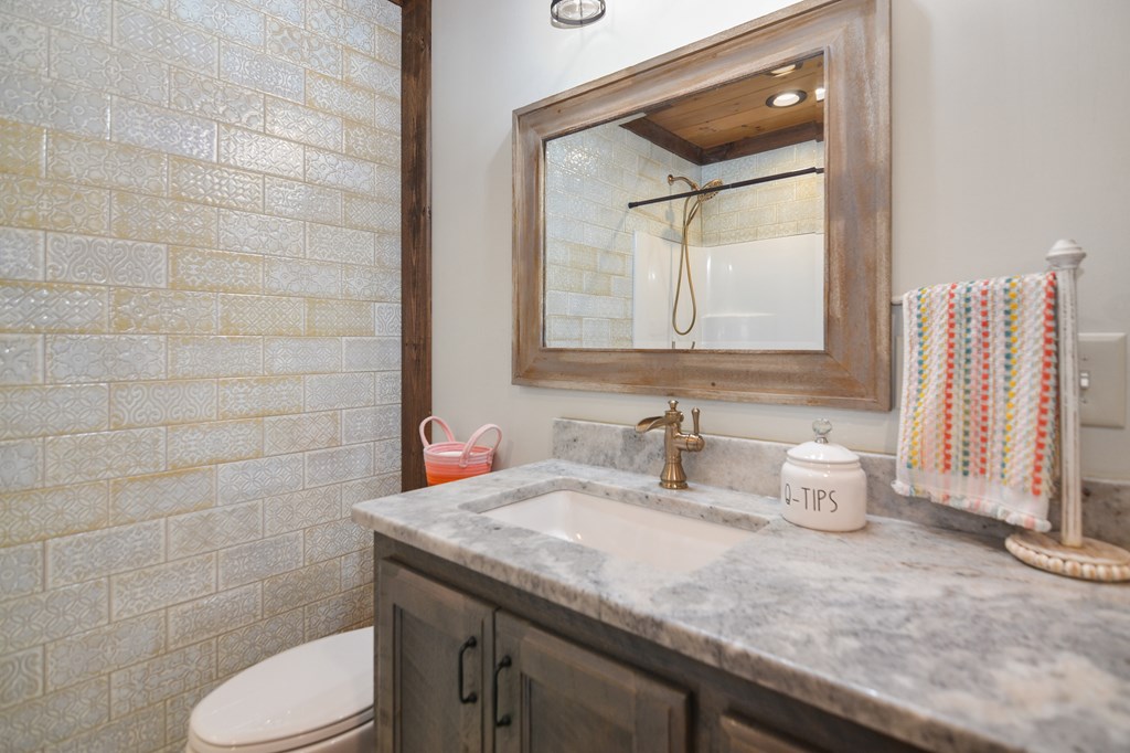 17 Emmaus Walk Blue Ridge, GA 30513 - Photo 28 of 59 a bathroom with a granite countertop toilet sink and mirror