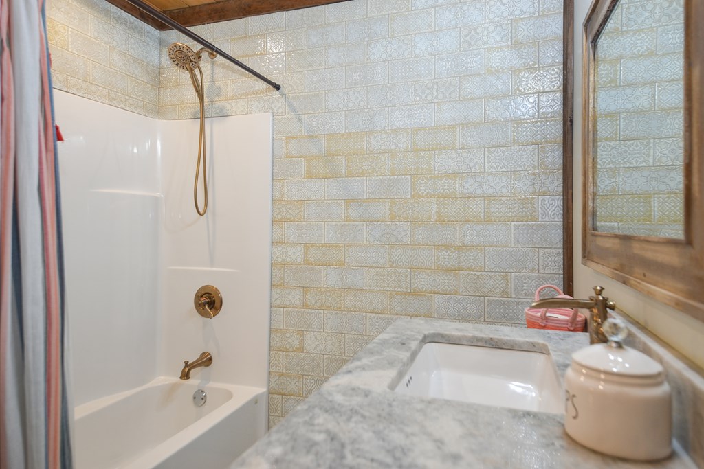 17 Emmaus Walk Blue Ridge, GA 30513 - Photo 29 of 59 a bathroom with a white bath tub a shower and a sink