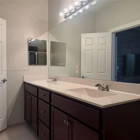 a view of an empty room with wooden floor and closet