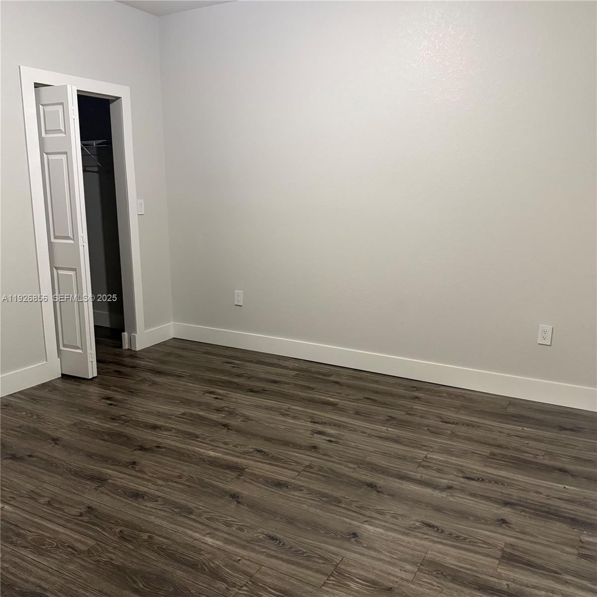10320 West 33rd Lane Hialeah, FL 33018 - Photo 13 of 29 a view of an empty room with wooden floor and closet