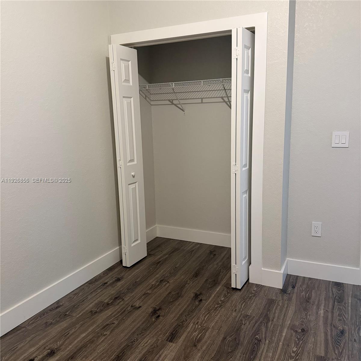 10320 West 33rd Lane Hialeah, FL 33018 - Photo 17 of 29 an empty room with wooden floor and closet