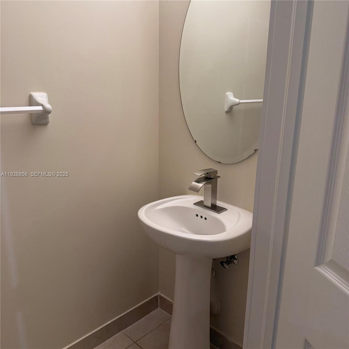 10320 West 33rd Lane Hialeah, FL 33018 - Photo 22 of 29 a bathroom with a sink a mirror and a window