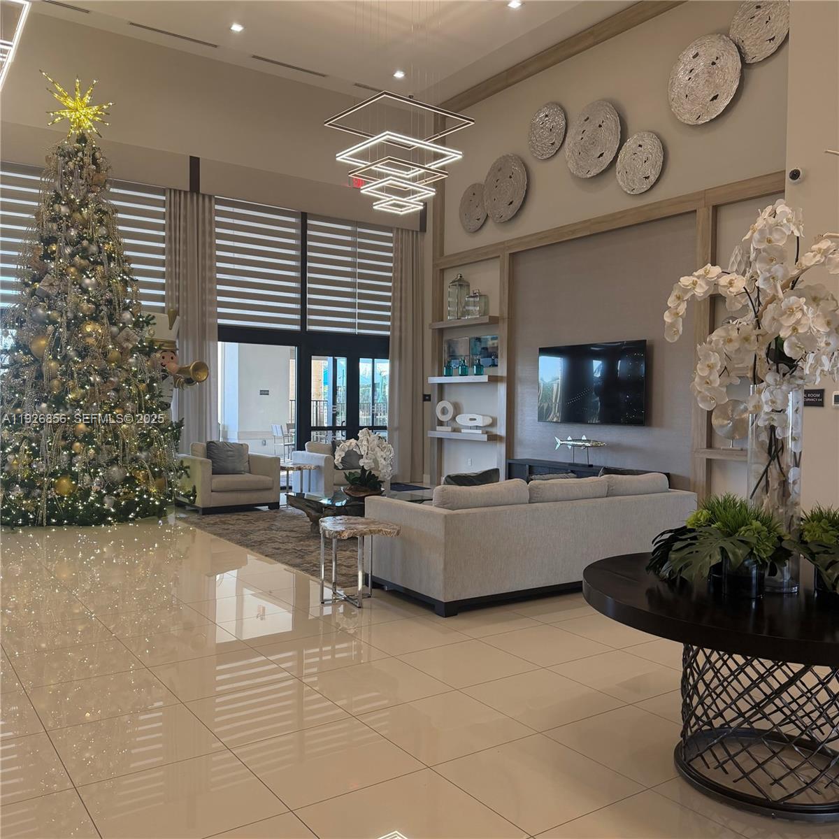 10320 West 33rd Lane Hialeah, FL 33018 - Photo 29 of 29 a living room with furniture a fireplace and a flat screen tv