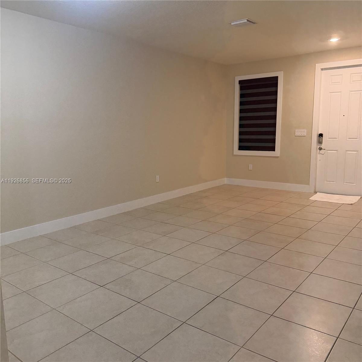 10320 West 33rd Lane Hialeah, FL 33018 - Photo 3 of 29 an empty room with windows