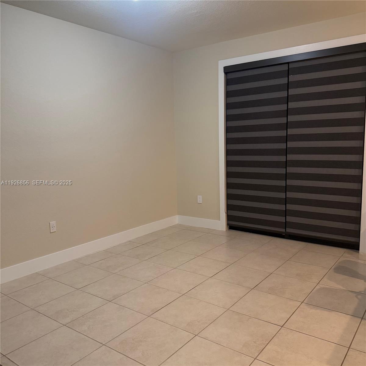 10320 West 33rd Lane Hialeah, FL 33018 - Photo 4 of 29 a view of an empty room and wooden floor