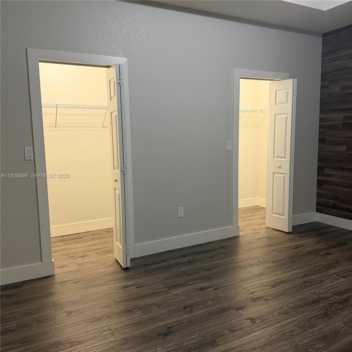 10320 West 33rd Lane Hialeah, FL 33018 - Photo 10 of 29 an empty room with wooden floor and a window