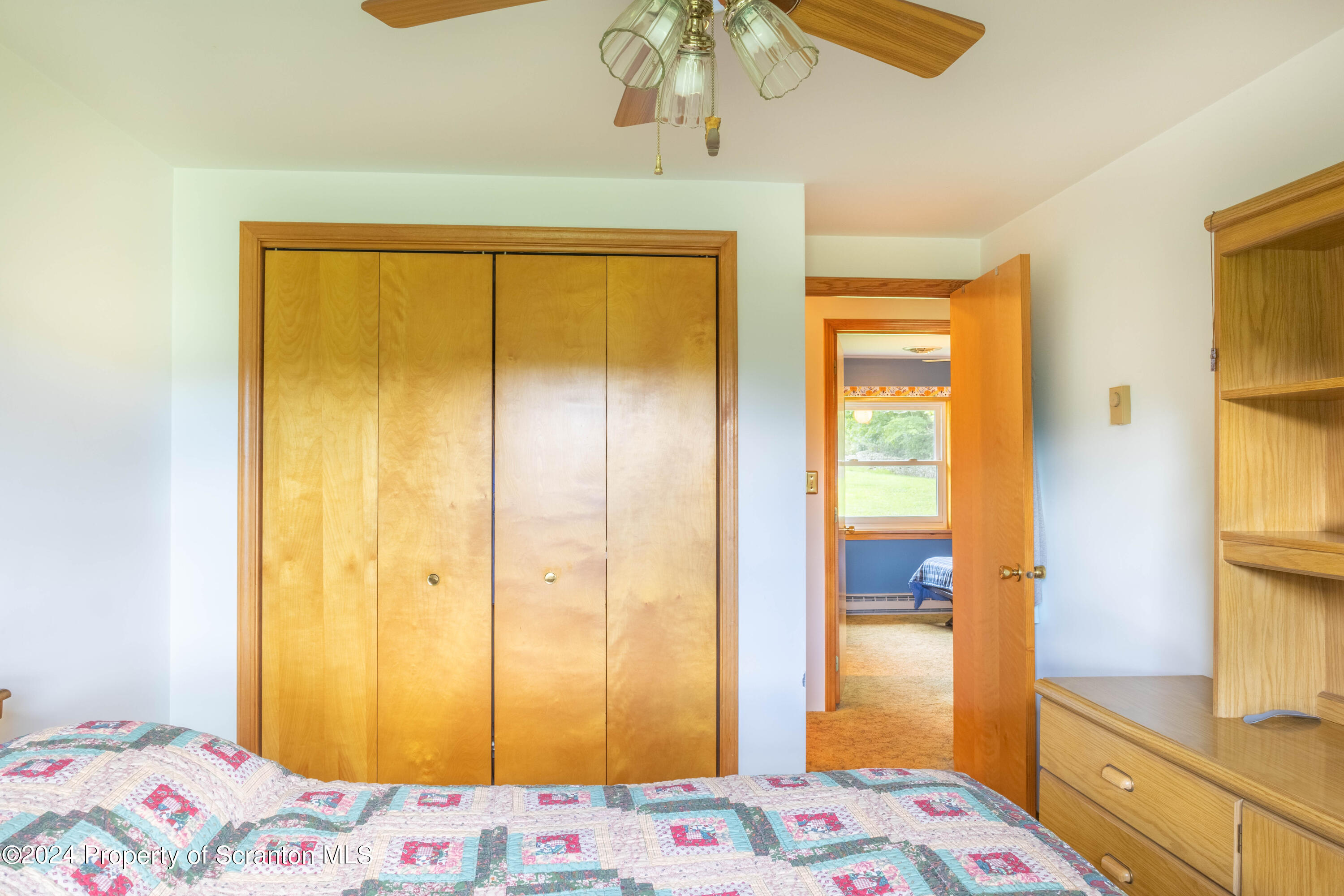 6509 State Rte 2012 Union Dale, PA 18470 - Photo 25 of 91 a bedroom with a bed and a chandelier