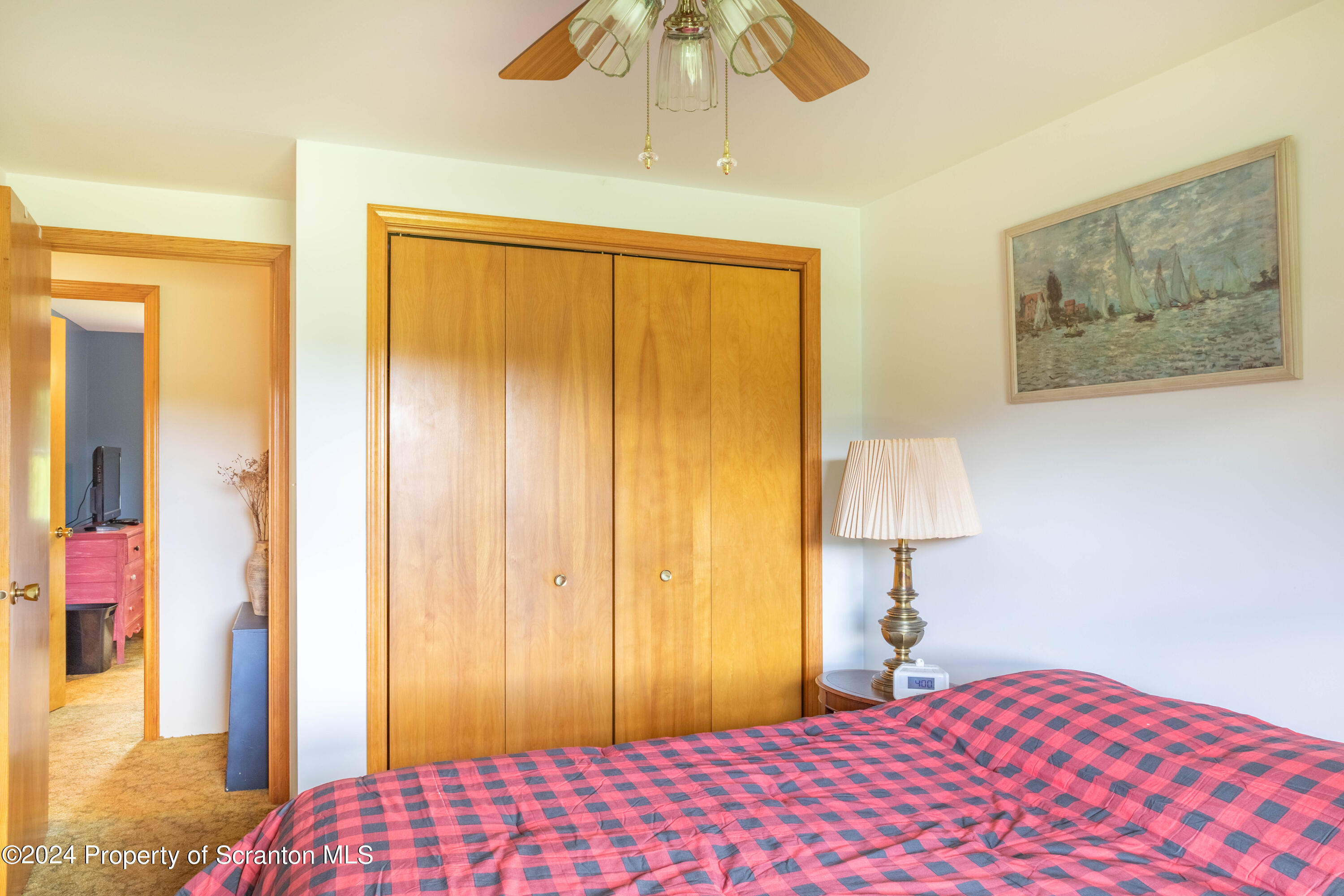 6509 State Rte 2012 Union Dale, PA 18470 - Photo 27 of 91 a bedroom with a bed and a chandelier